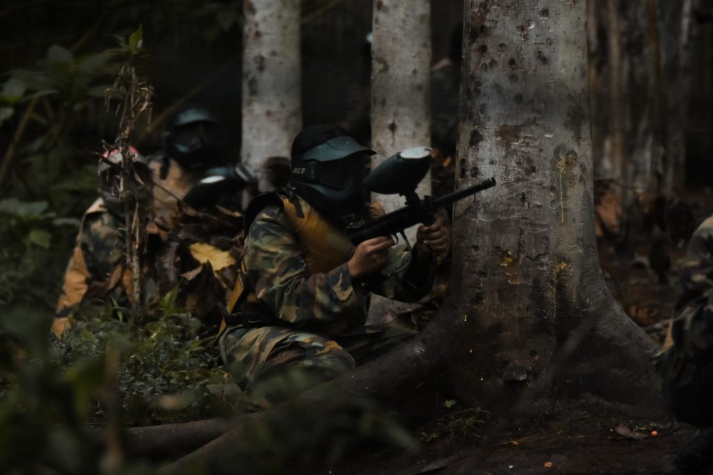 A group playing paintball on a Montana adventure vacation