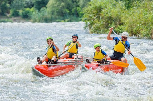 A group of people whitewater rafting