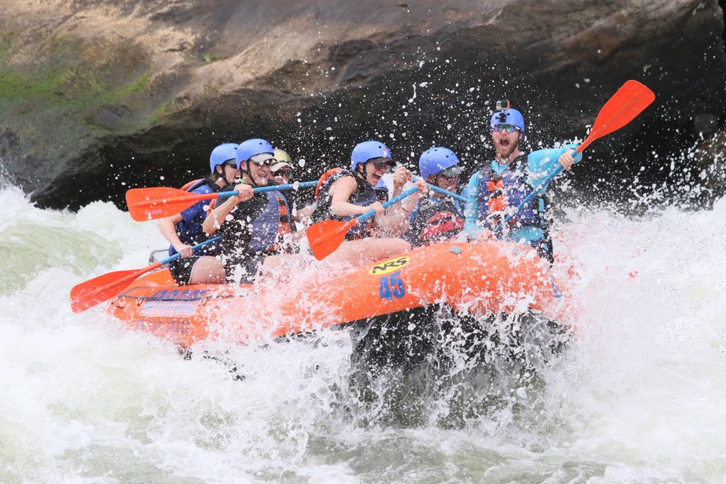 A group of people white water rafting