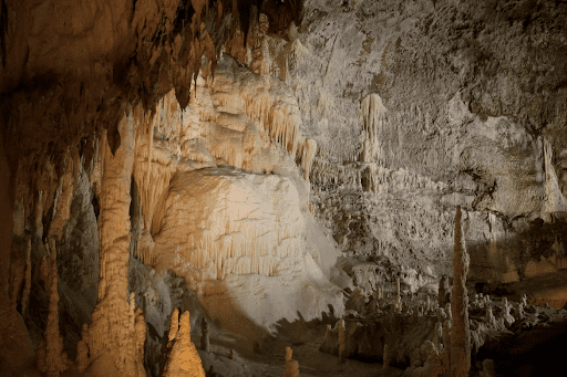 The inside of a cavern with stalagmites and stalactites
