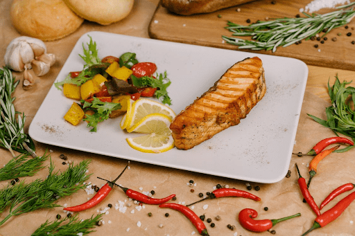 A dish with grilled fish and fresh vegetables