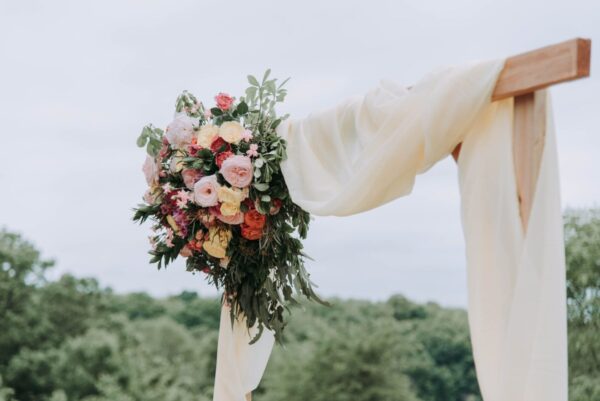 A bouquet of flowers hanging over an altar at a spring wedding venue