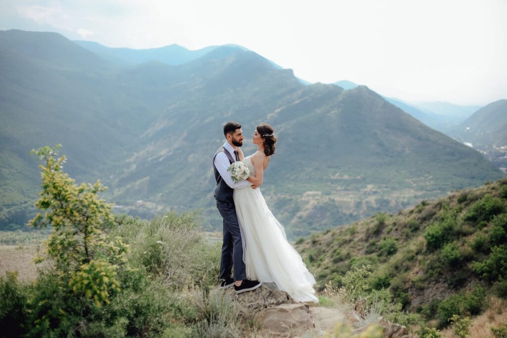 A bride and groom surrounded by mountains